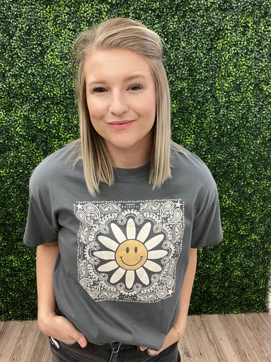 This is a charcoal gray cropped tee with a western floral print. It also features a daisy with a smiley face in the middle. It would pair perfectly with denim and a fun hat! Add some turquoise jewelry to complete the look. 